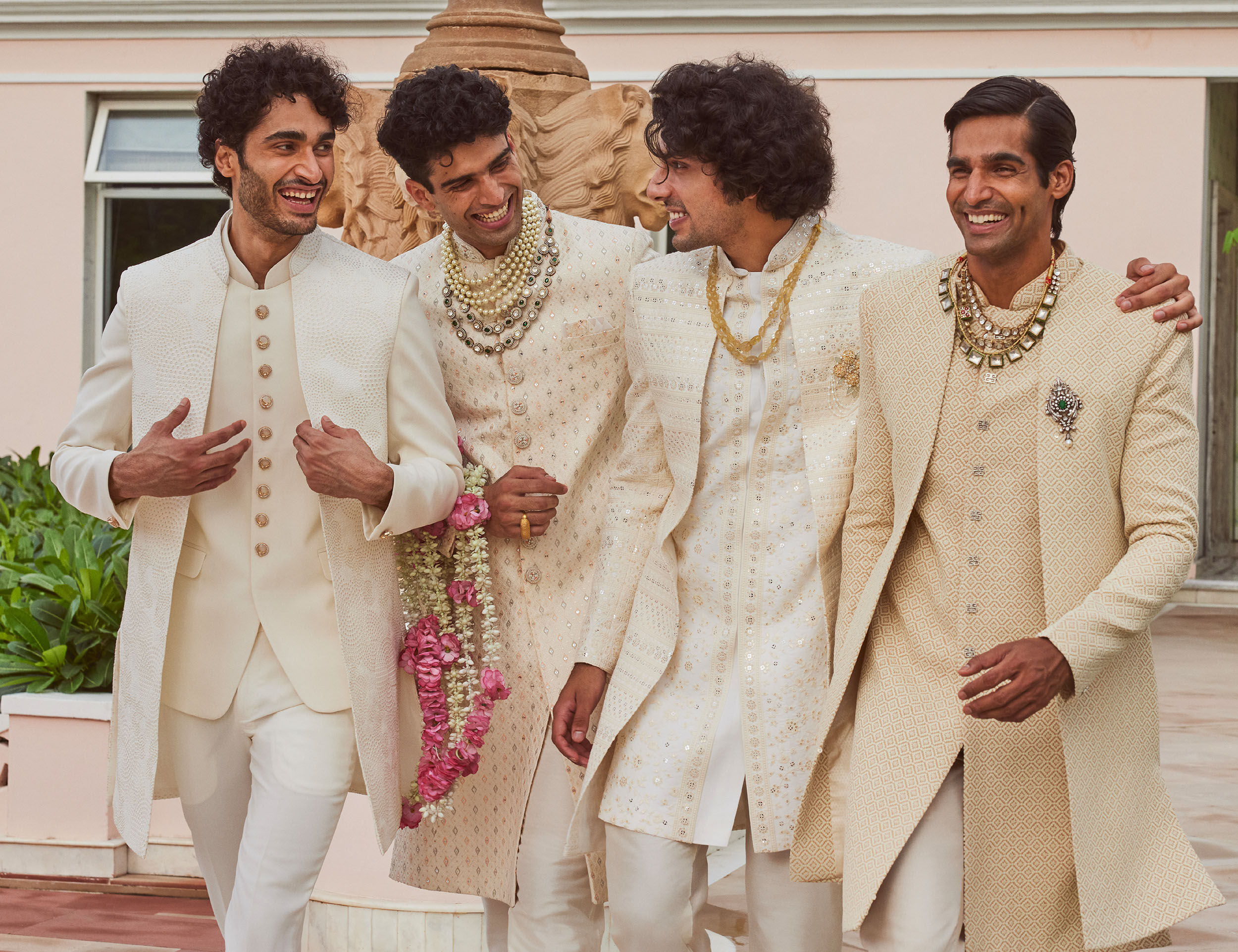 Group of men elegantly dressed in embellished chikankari kurta sets for a wedding celebration.